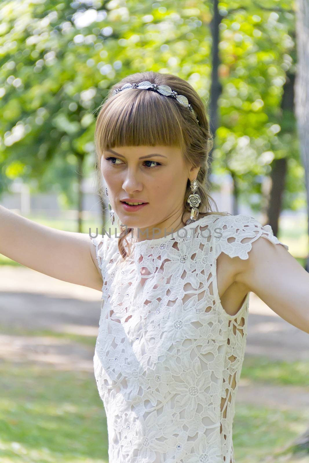 Beautiful portrait of bride with diadem in summer background