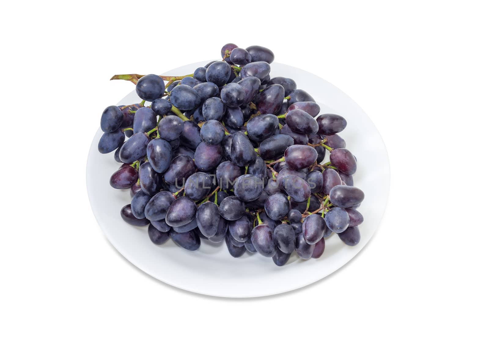 Cluster of the blue grapes on a white dish by anmbph