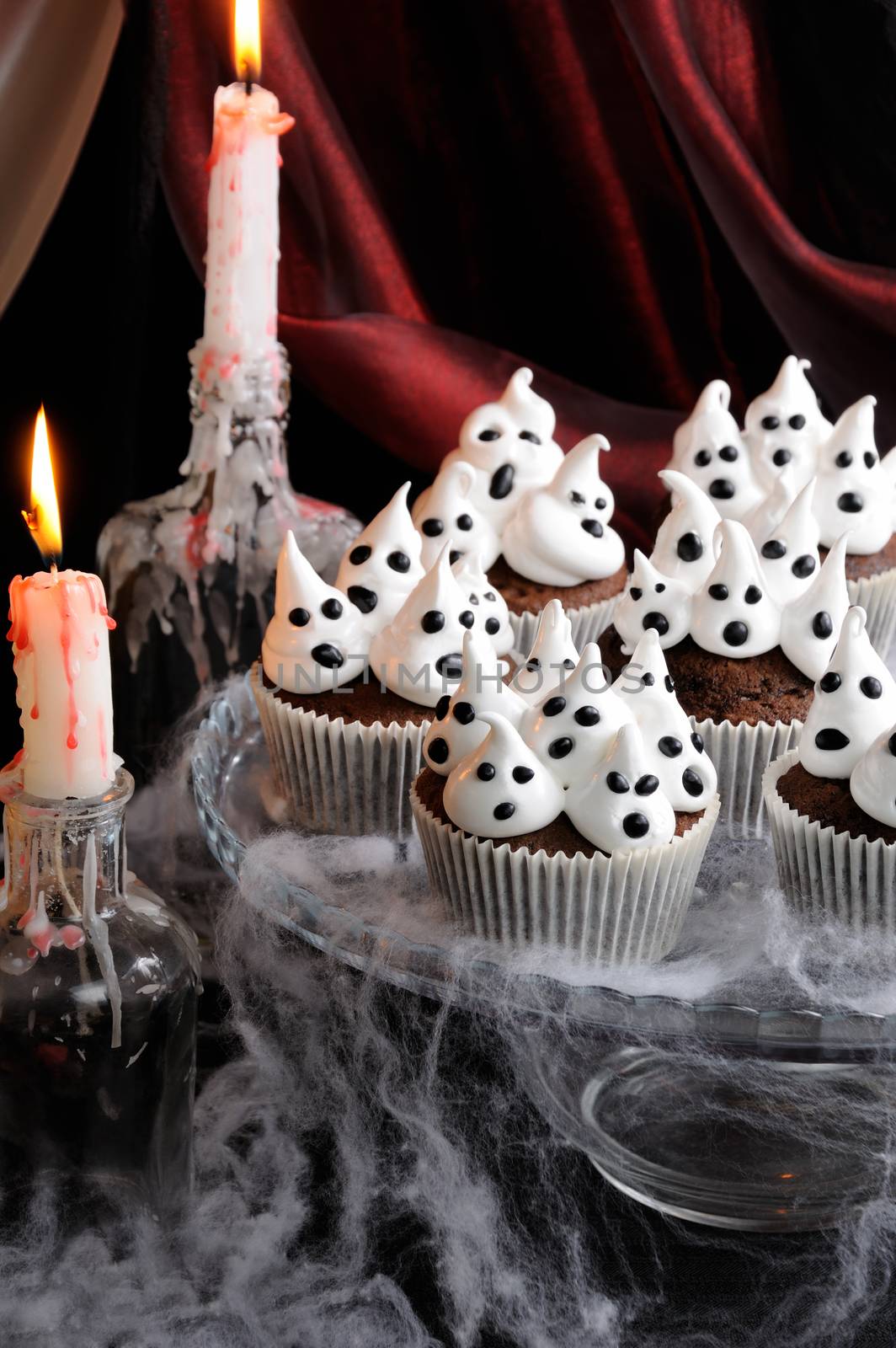 Chocolate muffin meringues with meringues on the table in honor of Halloween