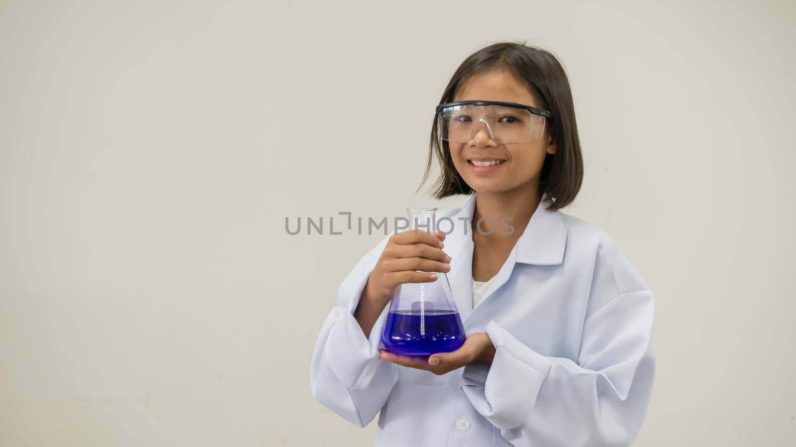 girl holding test tube by rakratchada