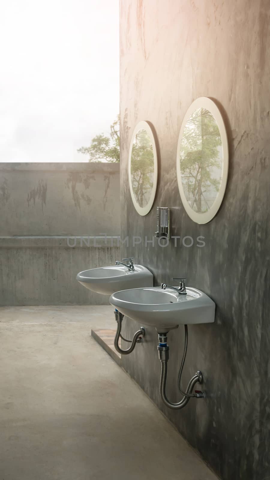 a white sinks and a stylish mirror