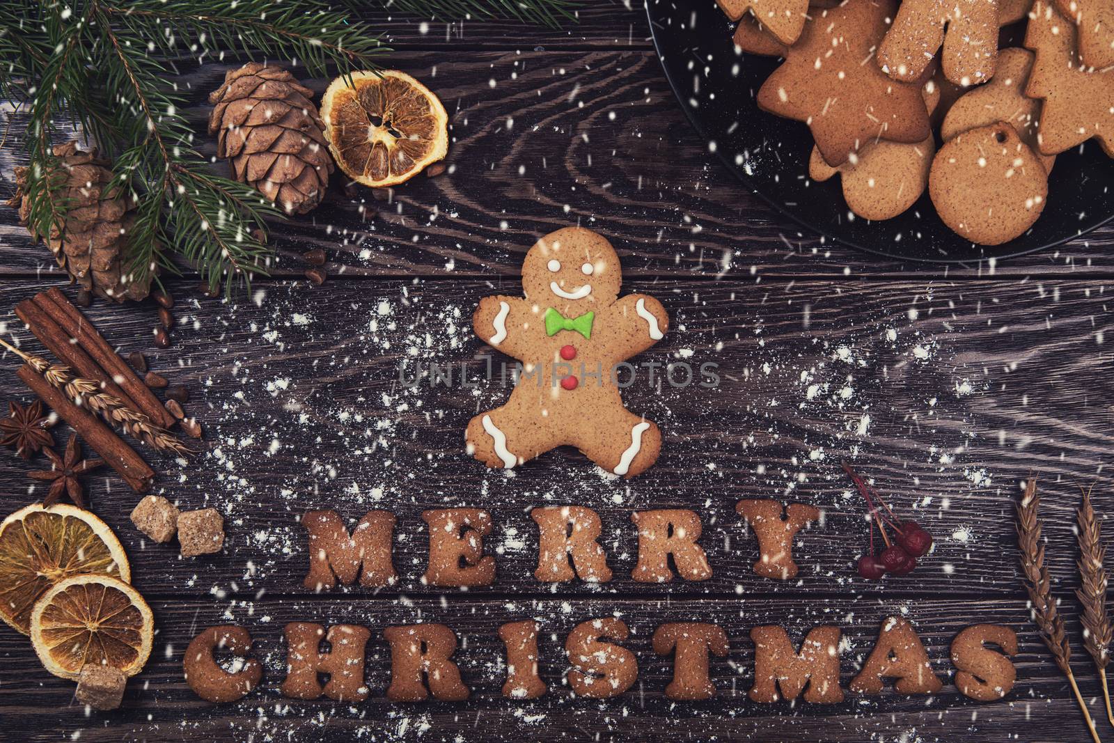 Gingerbreads for new years and christmas on wooden background with space for design