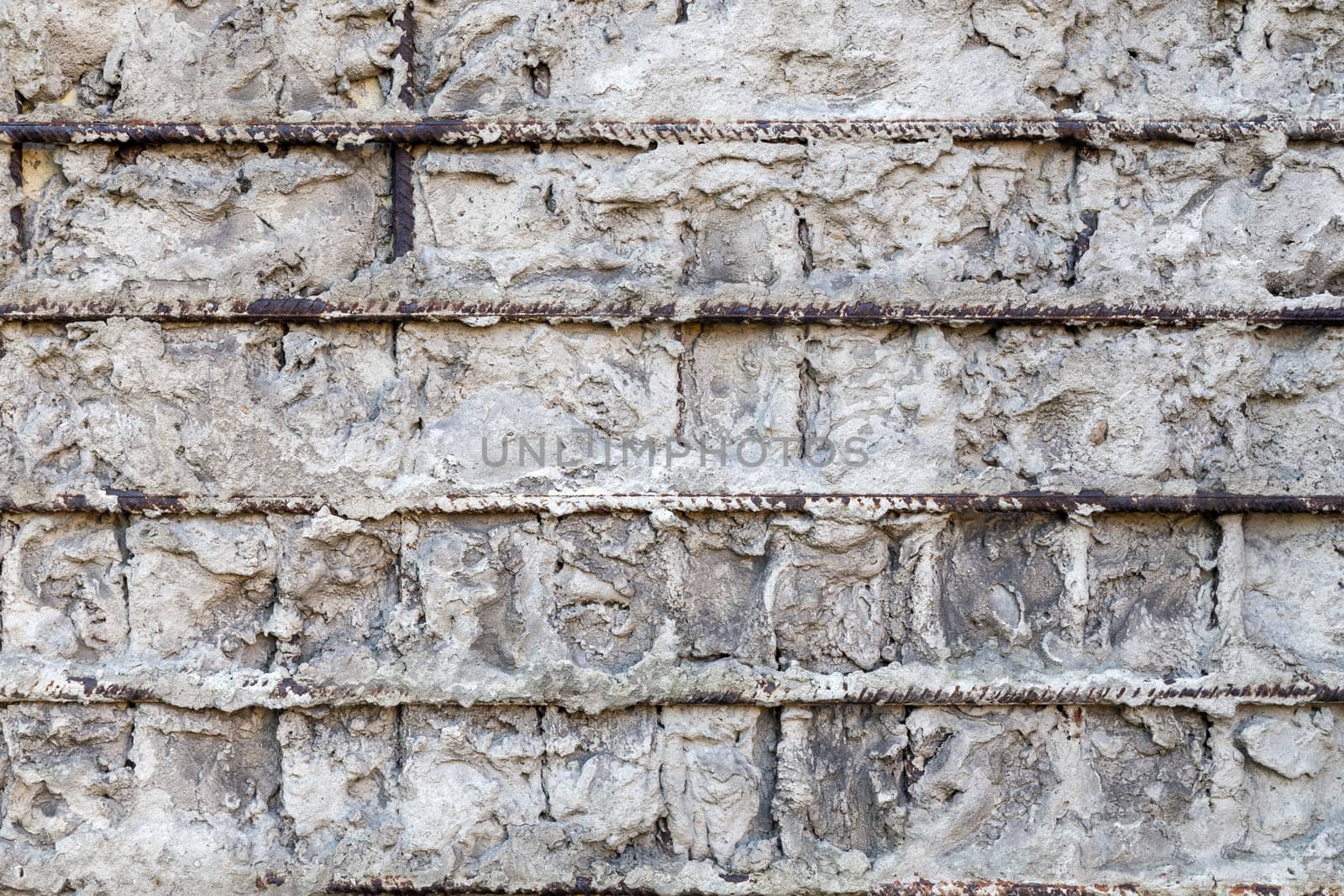 Fragment of a gray concrete wall with metal structures,background