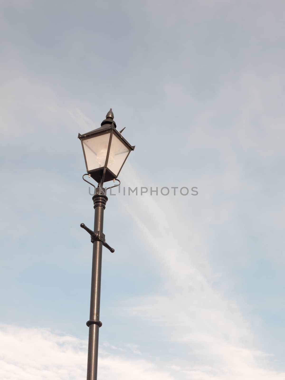 black outside street lamp with blue and cloud sky; Essex; England; UK