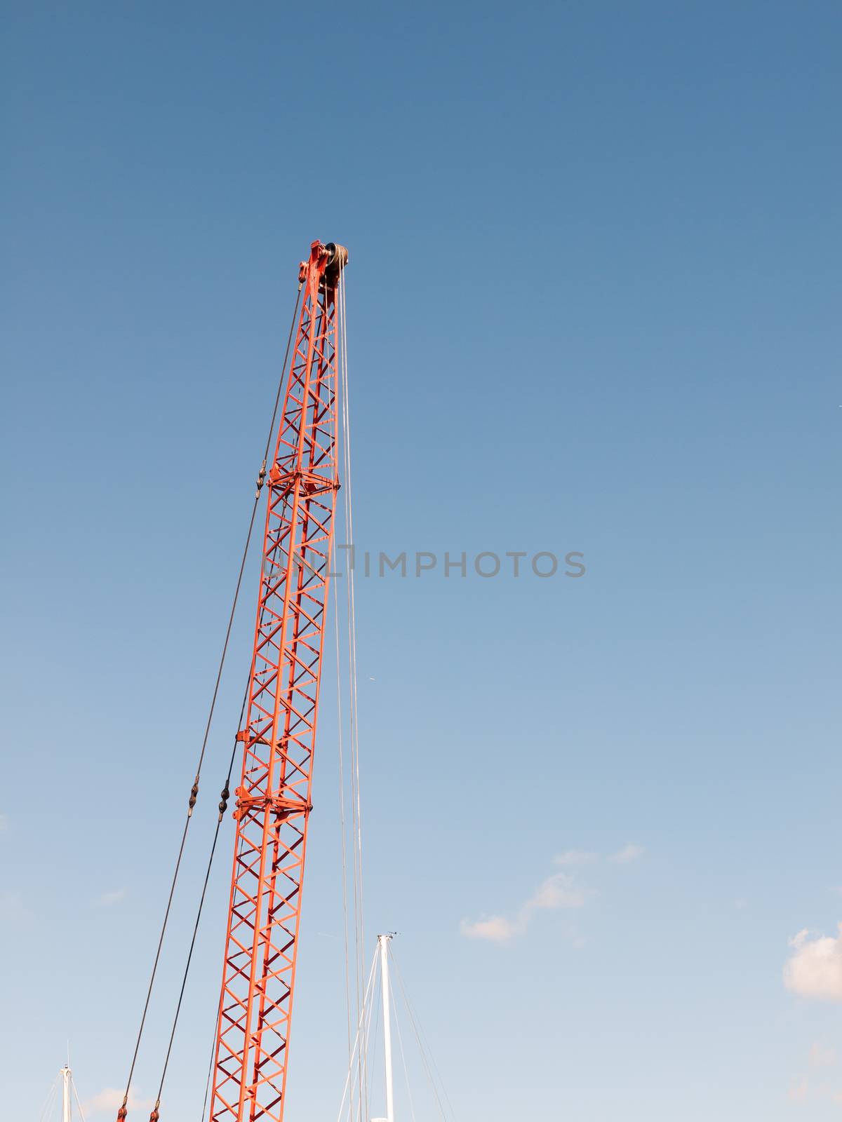 red crane top reaching into the blue sky above; essex; england; UK