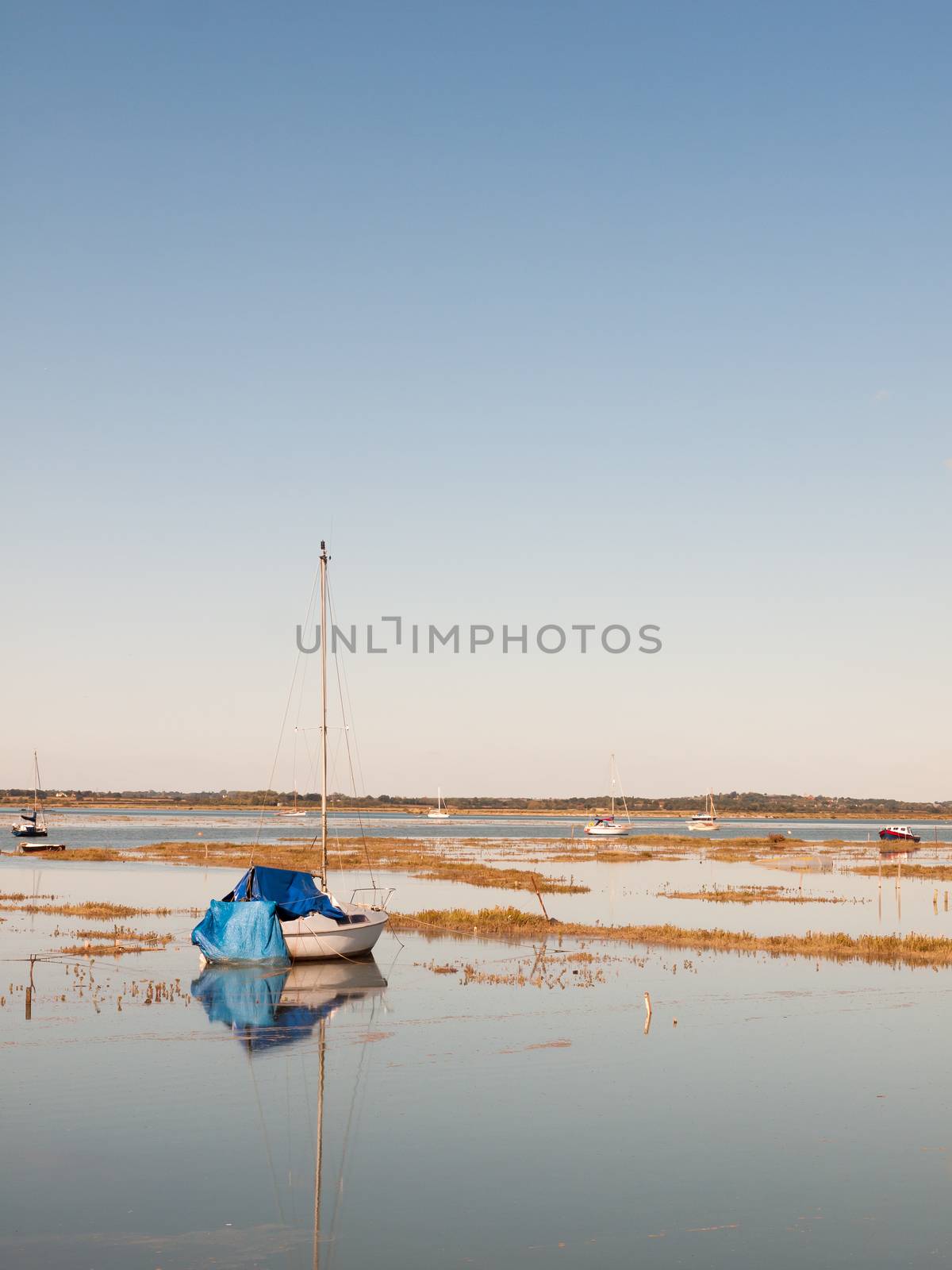 beautiful peaceful harbour scene estuary maldon boat mast reflections; essex; england; UK
