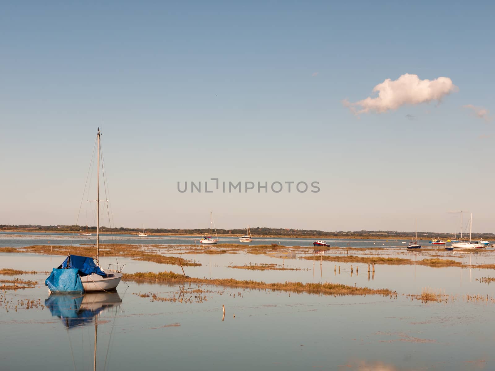 beautiful peaceful harbour scene estuary maldon boat mast reflections; essex; england; UK