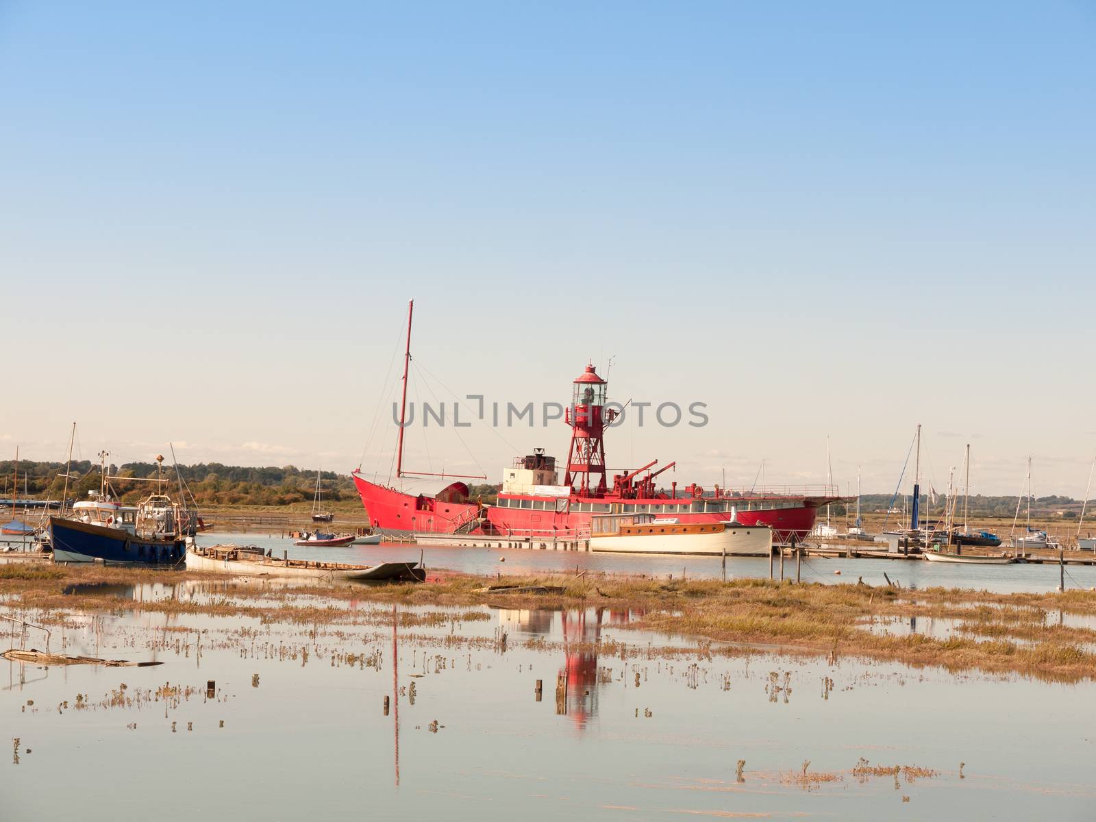 big red life boat moored in estuary tollesbury maldon by callumrc