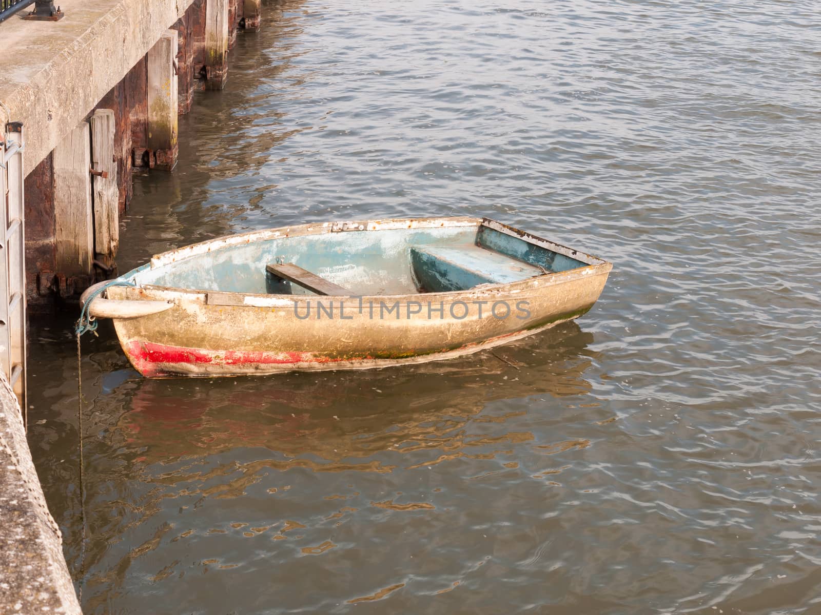 wooden row boat moored in river stream; Essex; England; UK