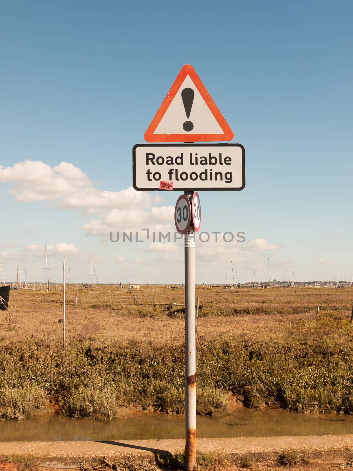 dock road sign red triangle exclamation road liable to flooding; essex; england; UK
