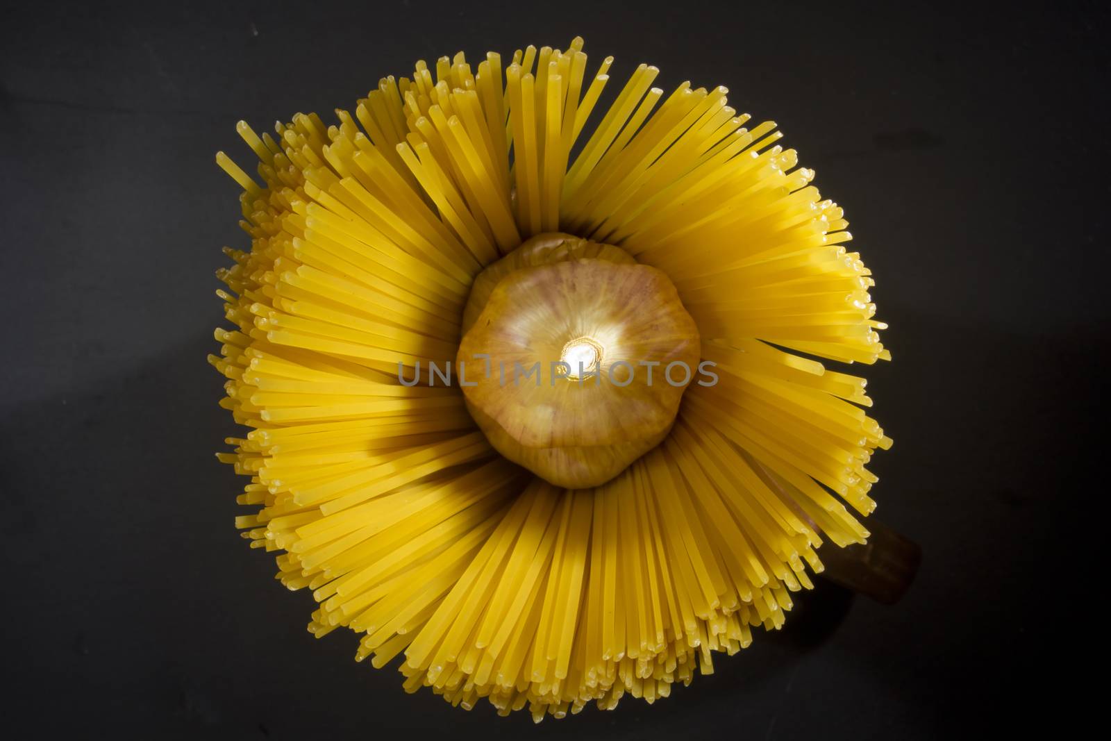 Macaroni and garlic on a black stone board