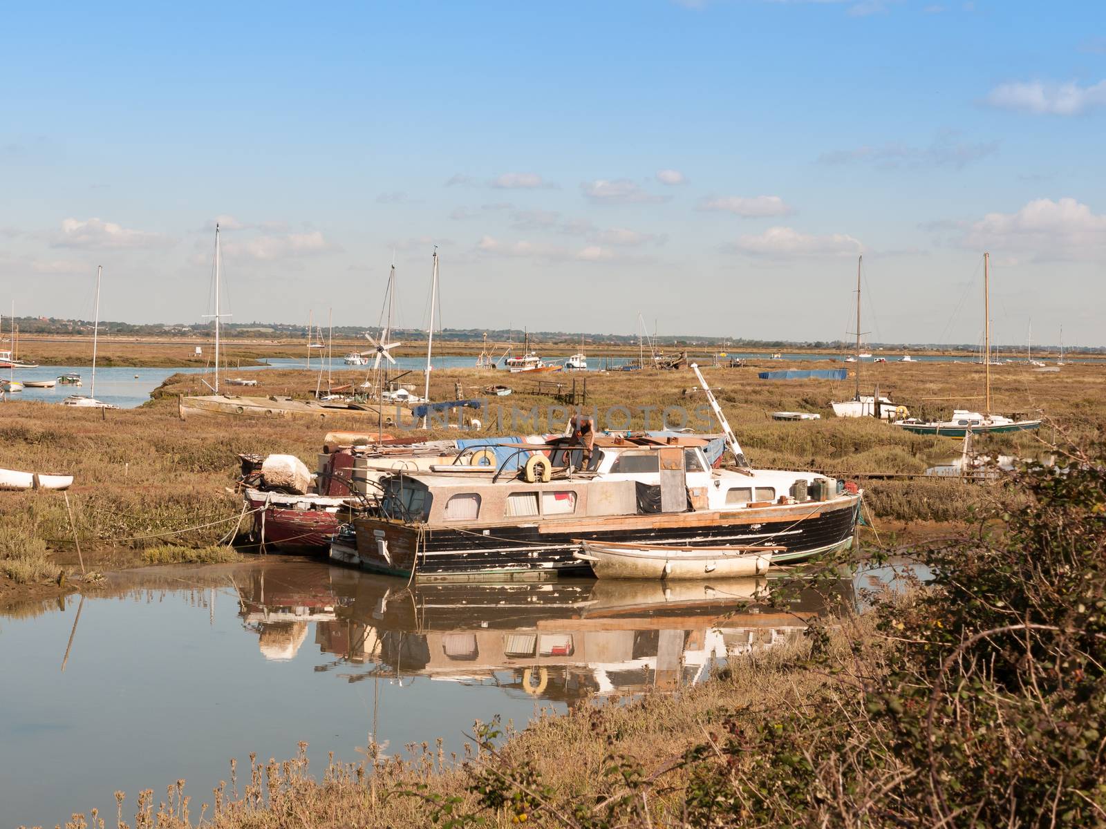 boats parked along estuary marshland in tollesbury maldon; essex; england; UK