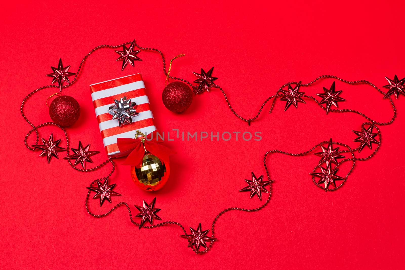 Christmas red background with gift and decoration by victosha