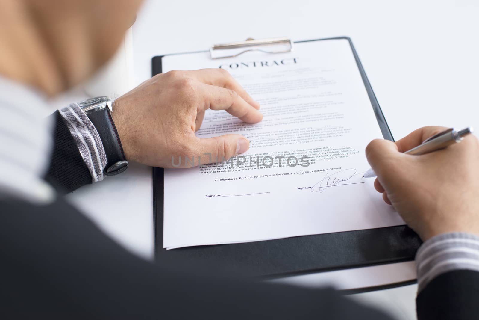 Businessman signing a contract by ALotOfPeople