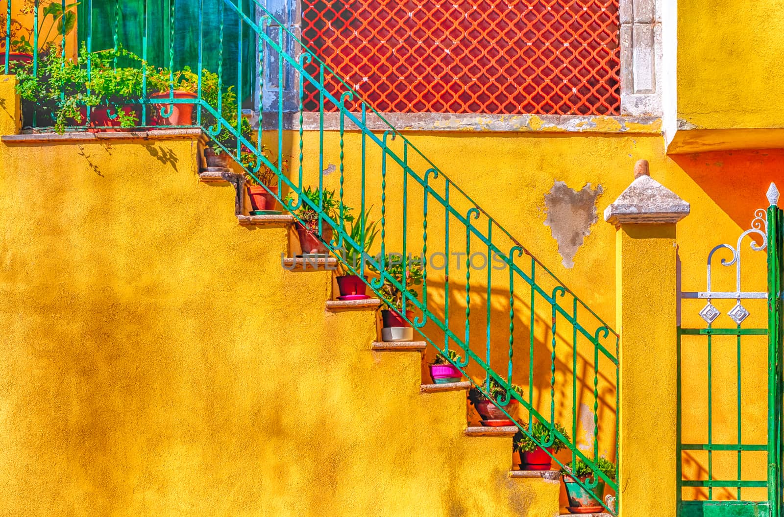 door and stairs on yellow wall in old alley