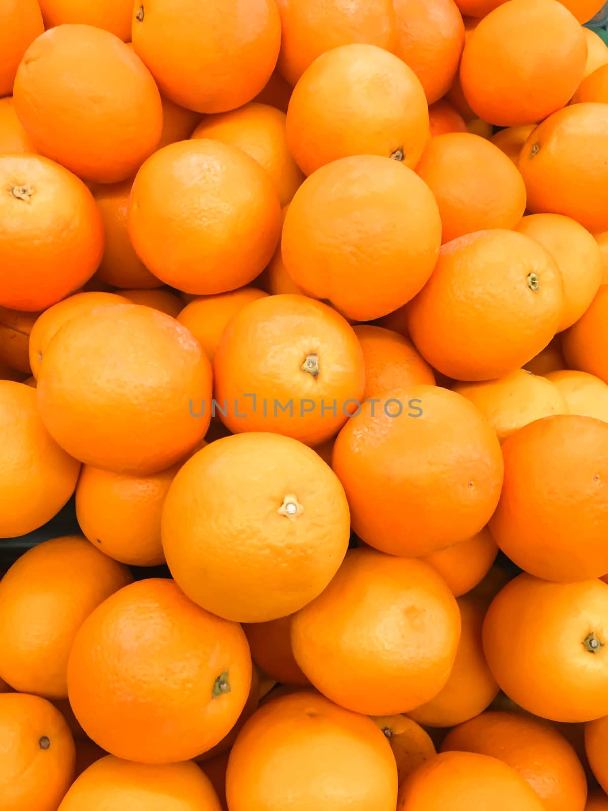 Closeup bunch of fresh oranges fruit on market, healthy food concept,Photo with mobile phone