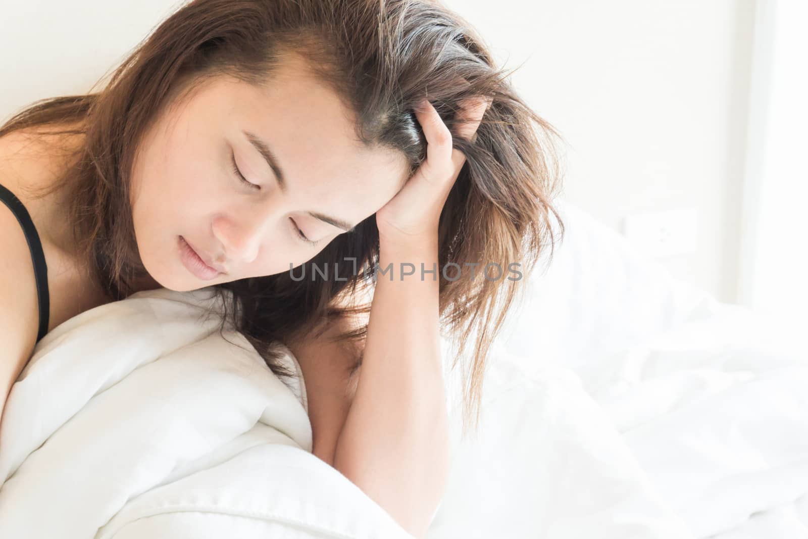 Closeup woman waking up with sore head on bed, health care and m by pt.pongsak@gmail.com