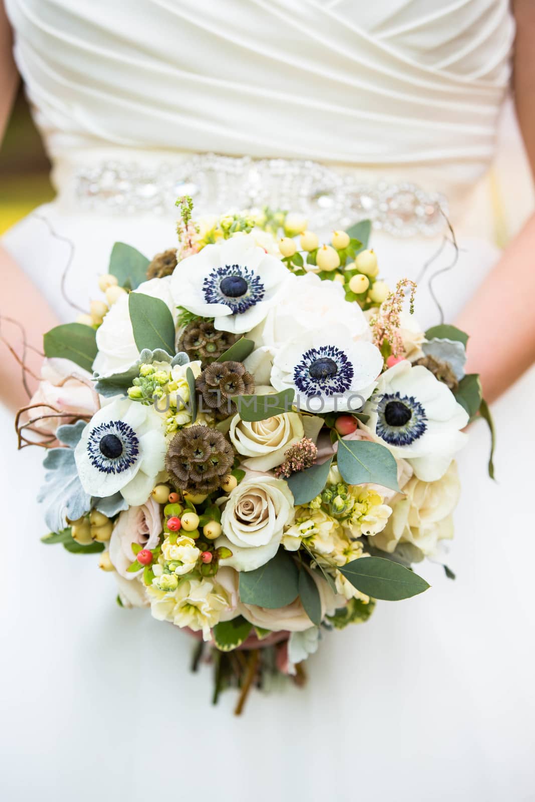 A close up shot highlighting the details of her beautiful wedding bouquet.