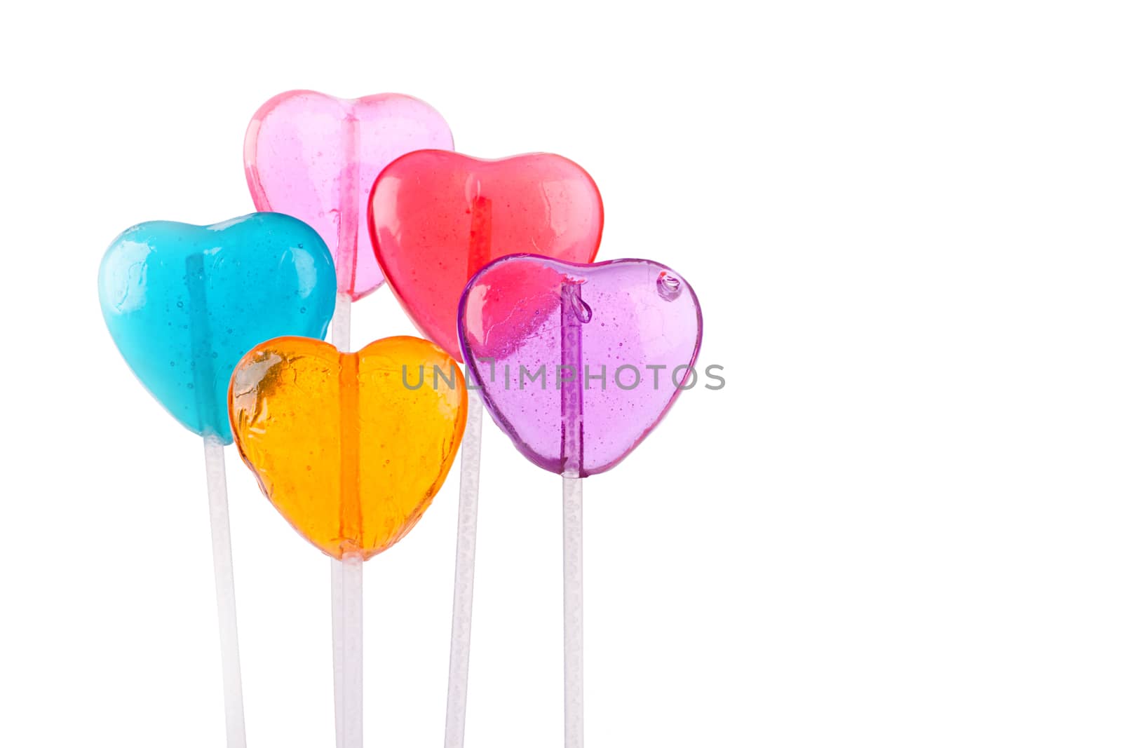 Five different colored heart lollipops on a white background.