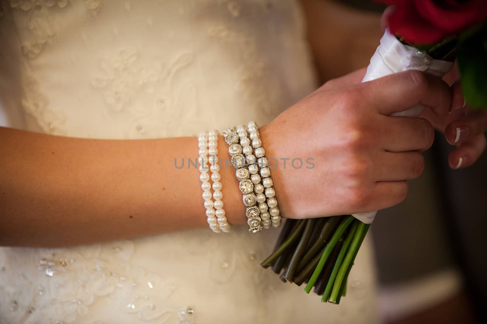 Close up of classy ivory bracelet on the wrist of a beautiful bride.