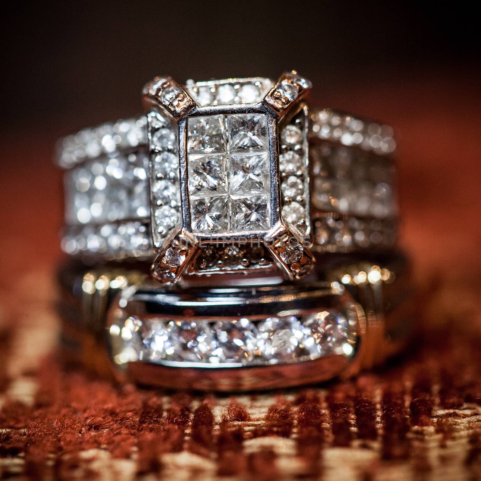 Close of gorgeous diamond wedding ring on a textured background.