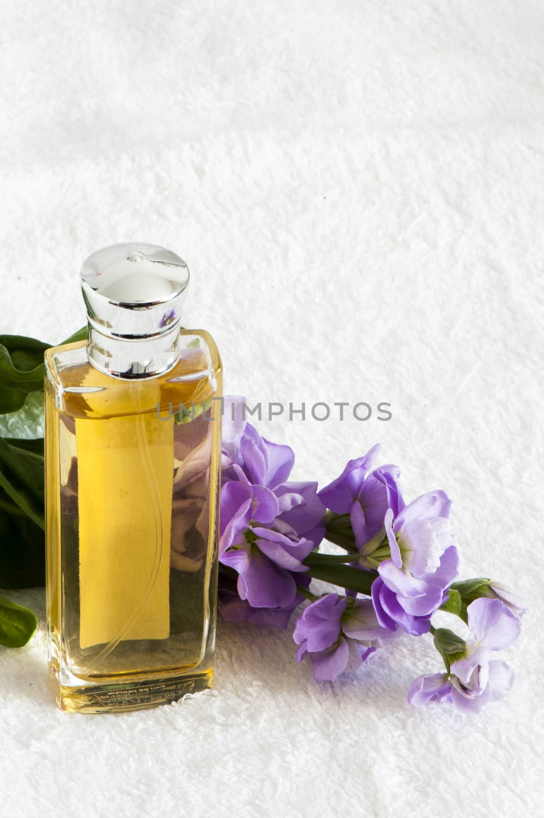 a perfume flask over a white towel