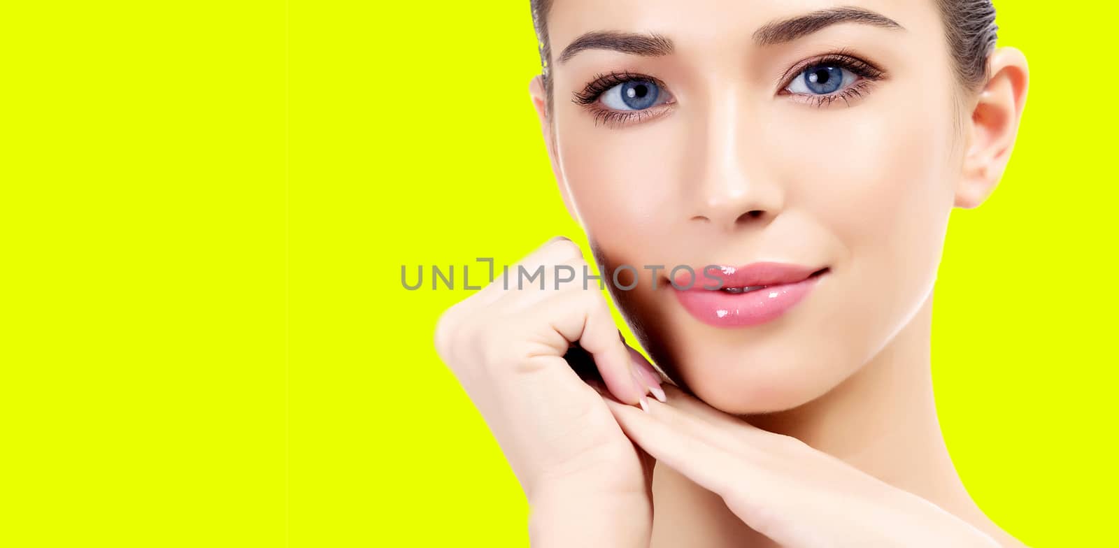 Pretty woman against a yellow background with copyspace