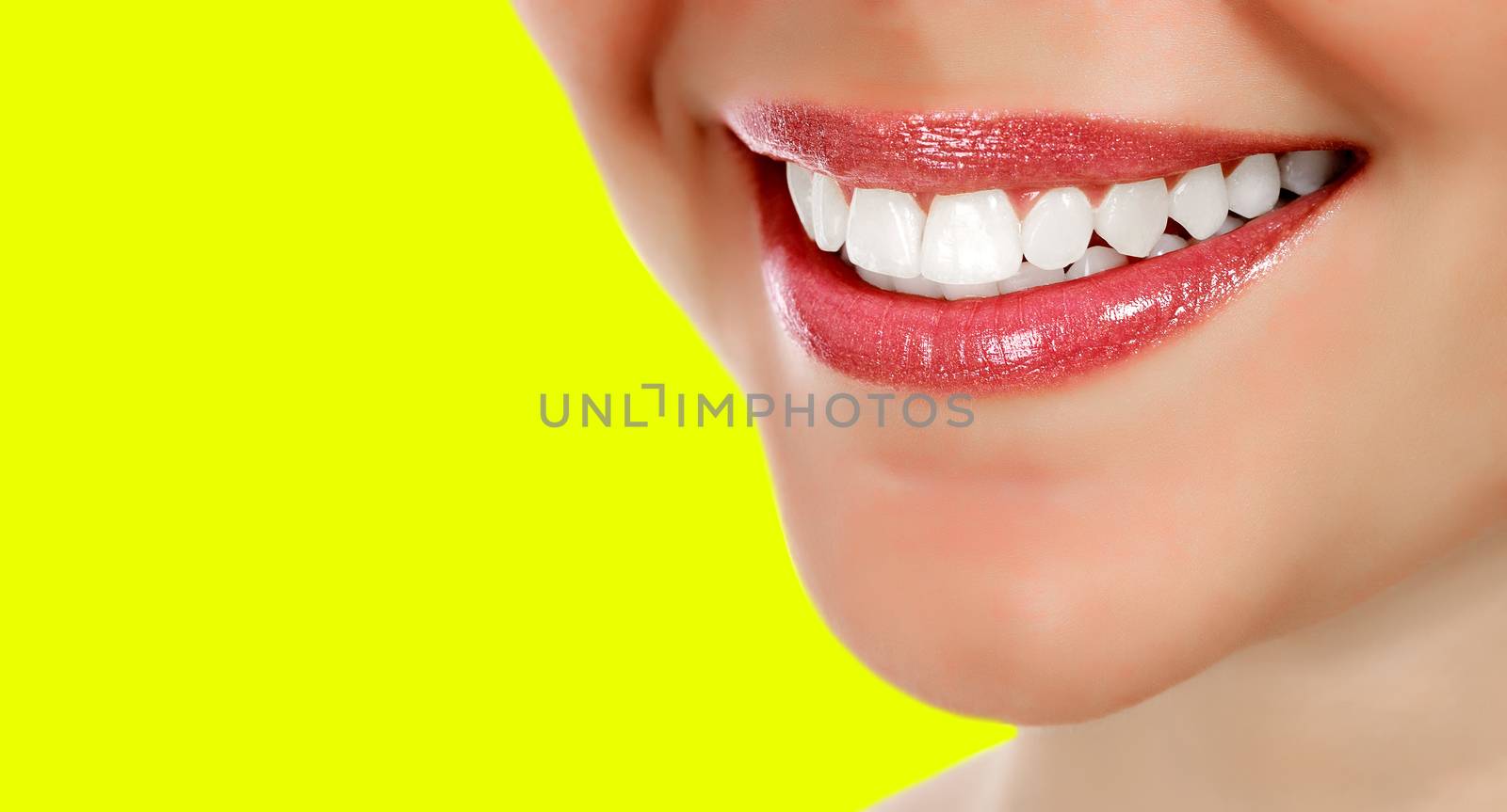 Pretty woman smiling against a yellow background with copyspace