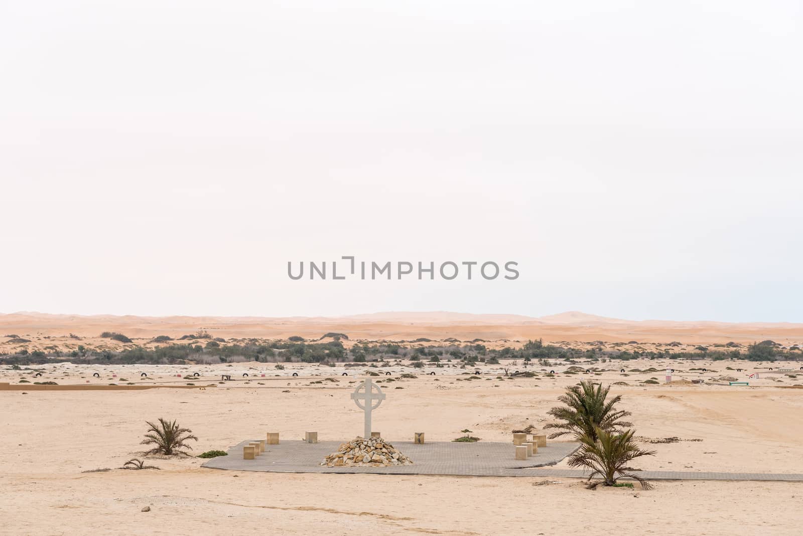 Part of the cemetry in Swakopmund in the Namib Desert on the Atlantic Coast of Namibia. The Swakop River and sand dunes are in the back