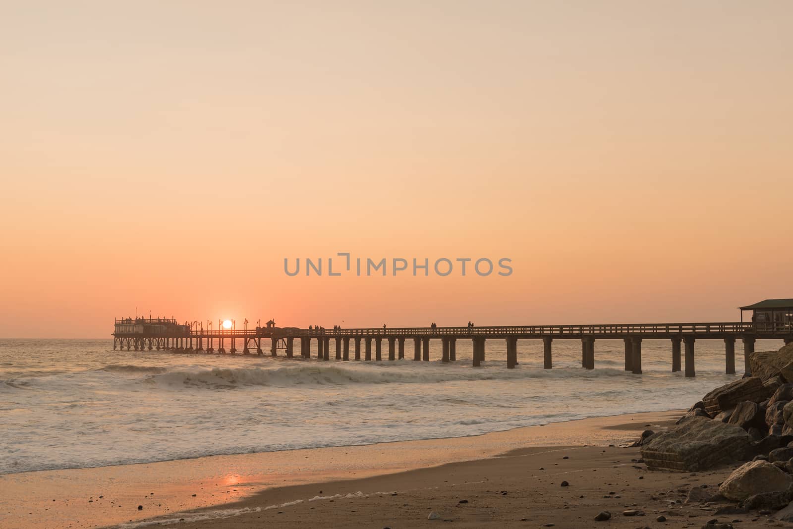 Silhouette of the historic jetty against the setting sun, in Swakopmund in the Namib Desert on the Atlantic Coast of Namibia