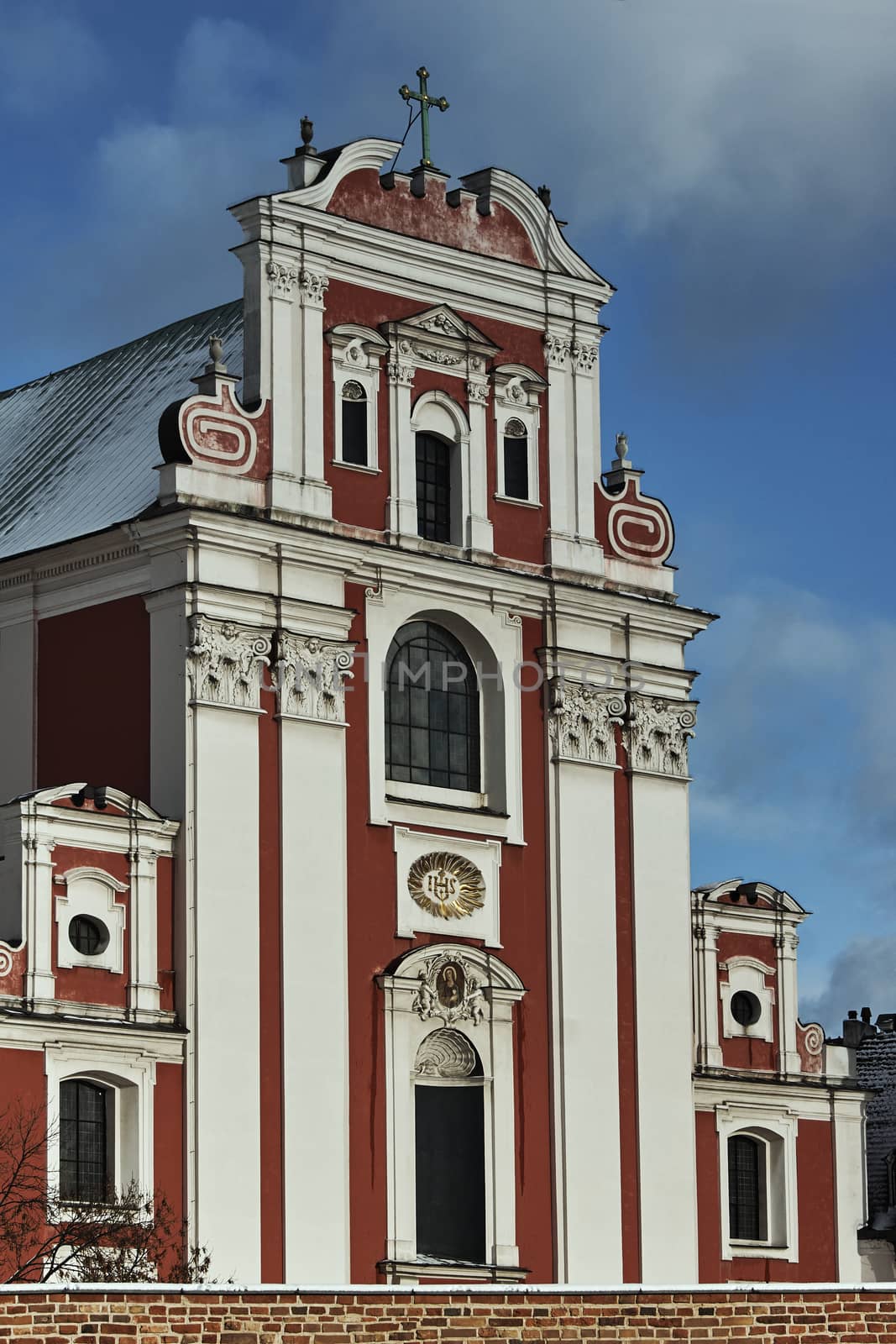 Baroque Catholic Church behind medieval defensive wall in Poznan