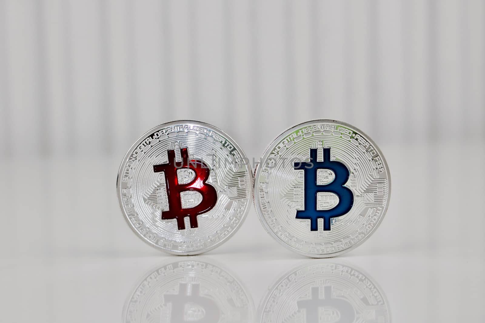 Digital currency physical silver bitcoin coin red and blue scene.