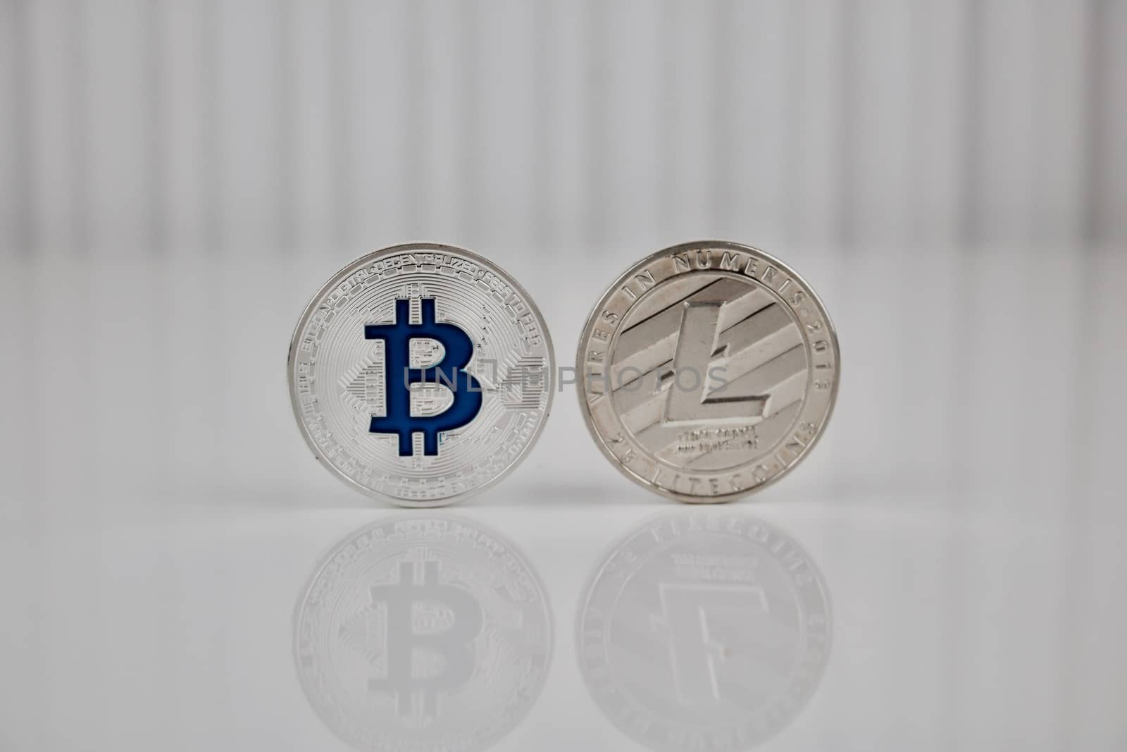 Cryptocurrency physical silver bitcoin and silver litecoin coin.