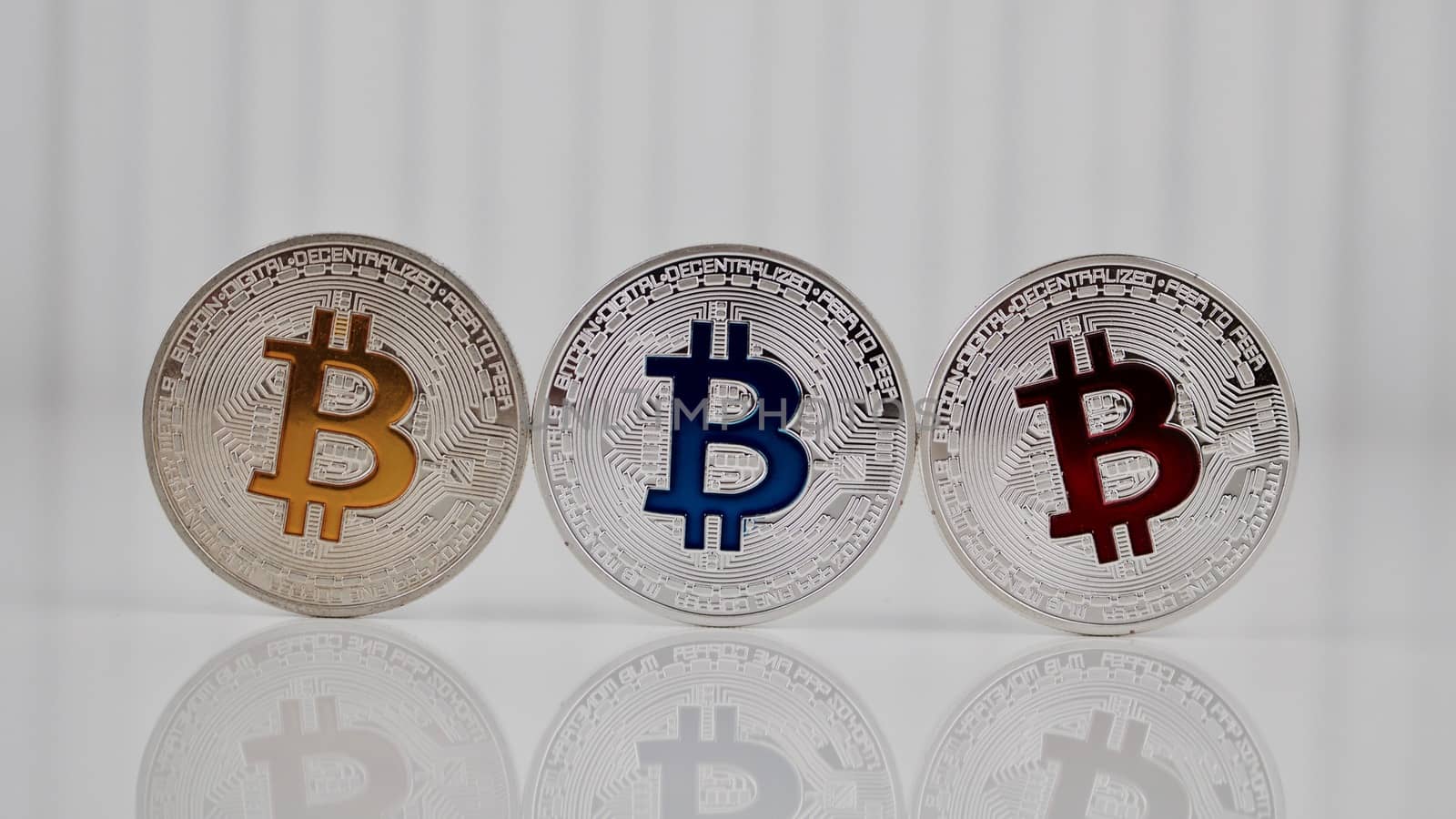 Digital currency physical silver bitcoin coin on the table. Colorful concept.