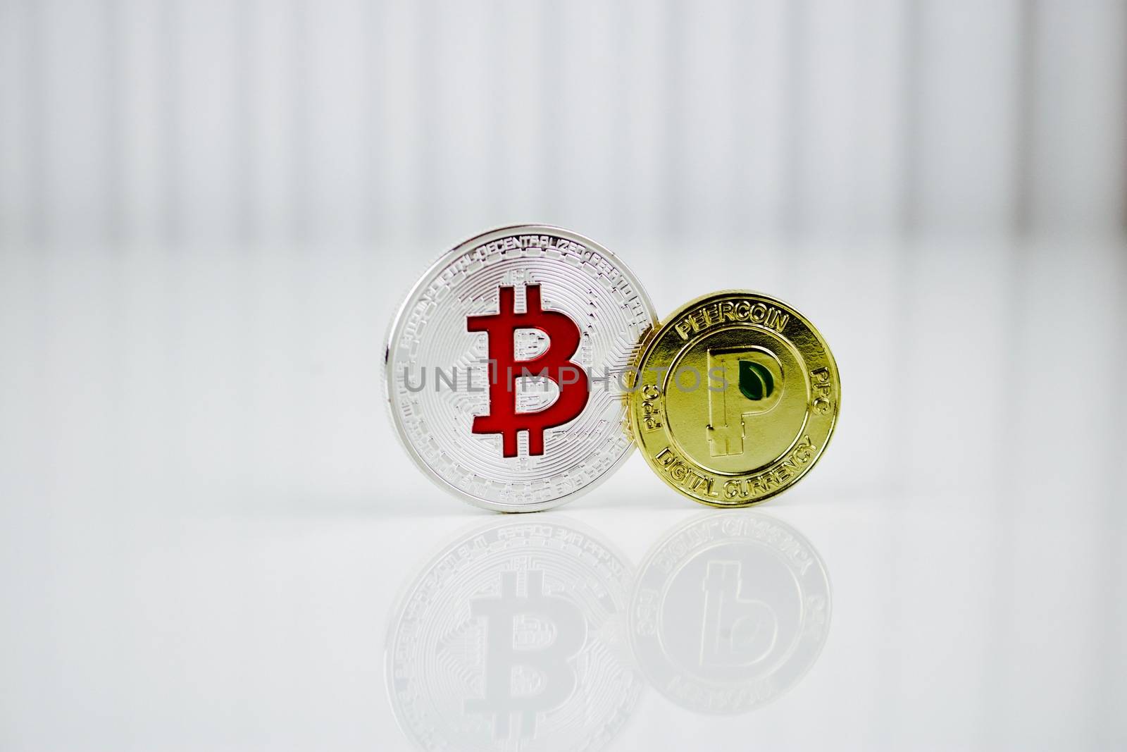 Digital currency physical silver bitcoin and gold peercoin coin.