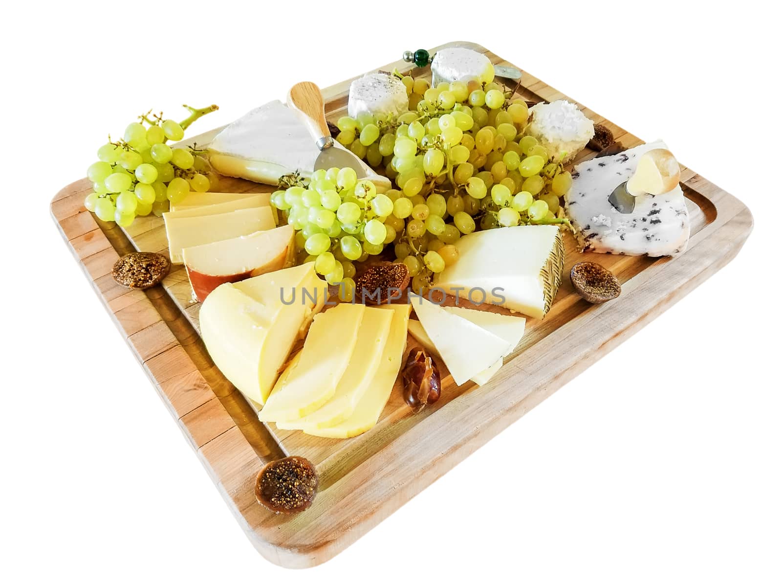 Gouda cheese, Brie, Wensleydale cheese with cranberries, and other cheeses, with green grapes, and figs, on a cutting board, isolated over white nackground.