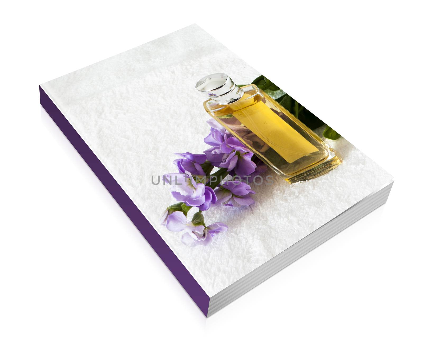 book of a perfume flask over a white towel