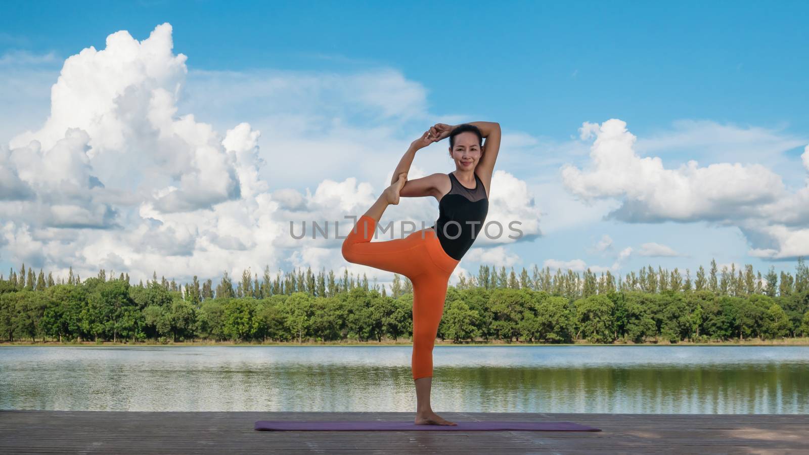 Asian woman practicing yoga pose by rakratchada
