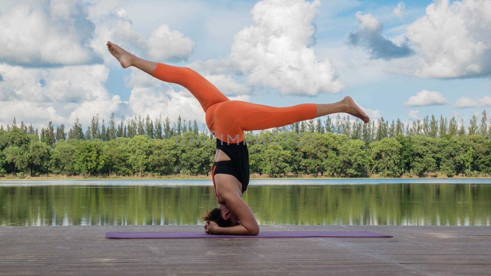 Asian woman practicing yoga pose by rakratchada