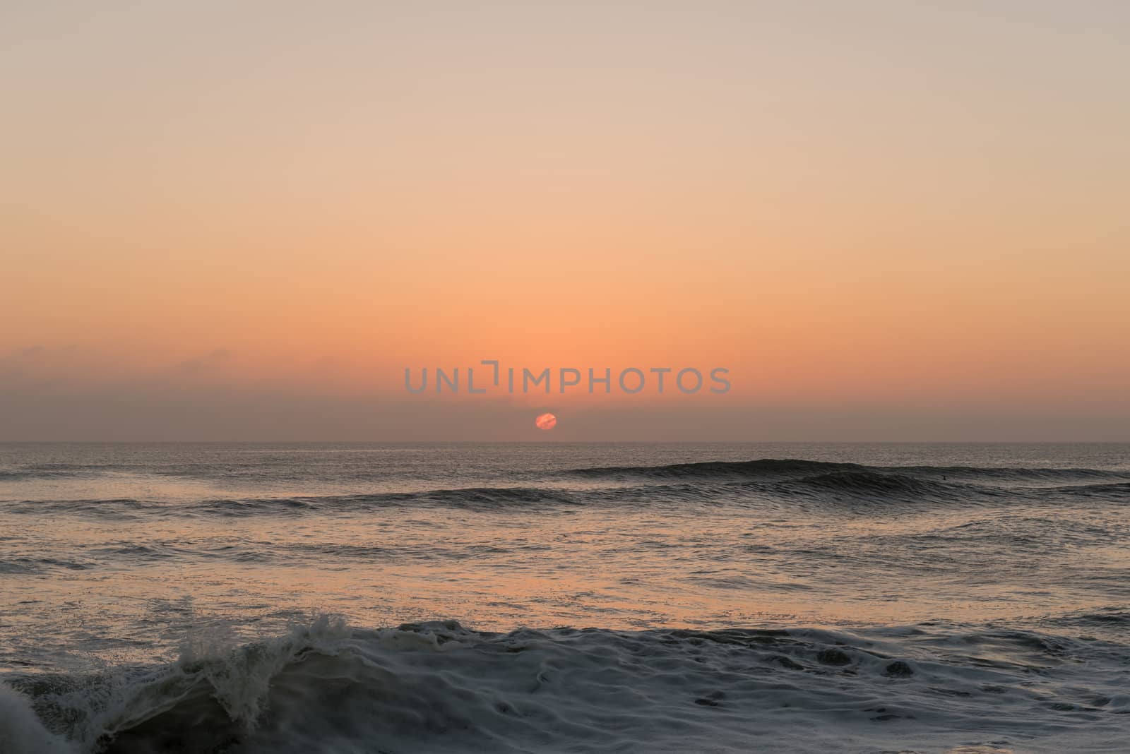 The sun sets over the Atlantic Ocean at Cape Cross on the Skeleton Coast of Namibia