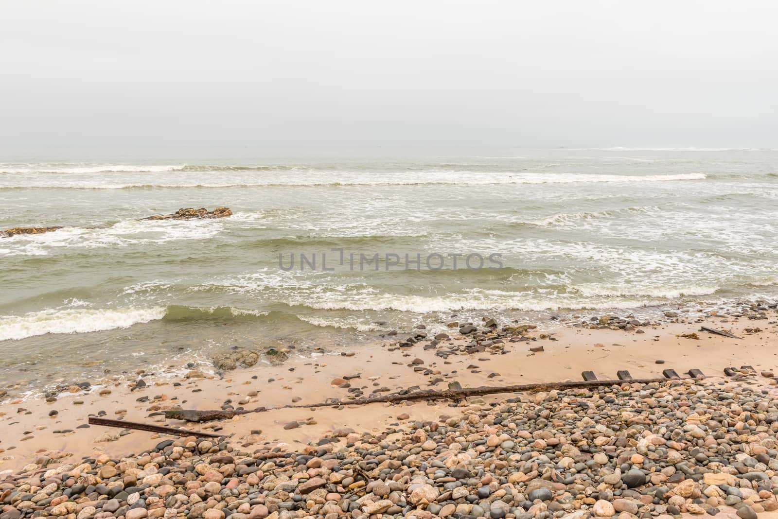Rusted railroad tracks at the mouth of the Swakop River at Swakopmund in the Namib Desert