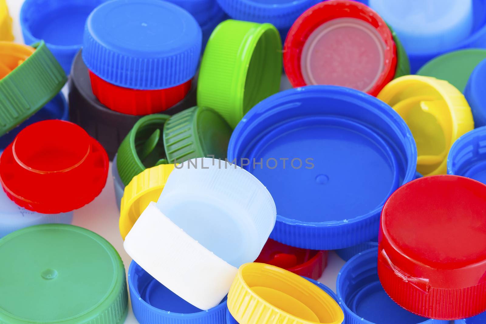 Colorful plastic bottle caps closeup, recycled garbage