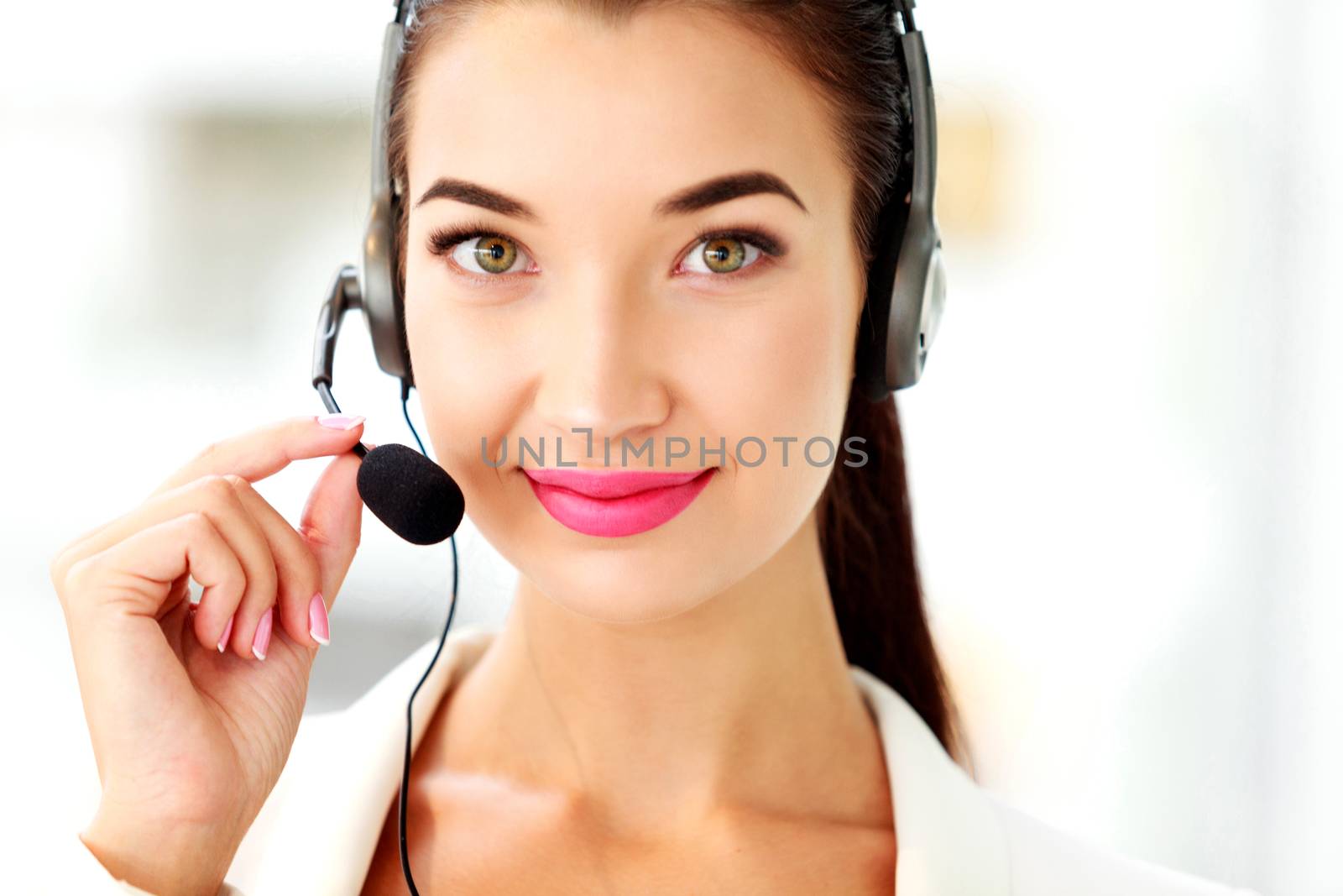 Closeup portrait of support phone operator in headset at workplace
