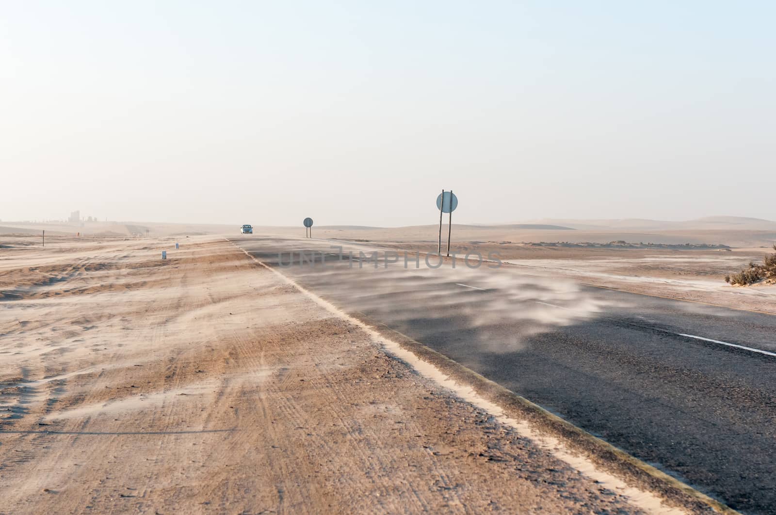 Sand being blown over the B2-Road near Longbeach in the Namib Desert on the Atlantic Coast of Namibia