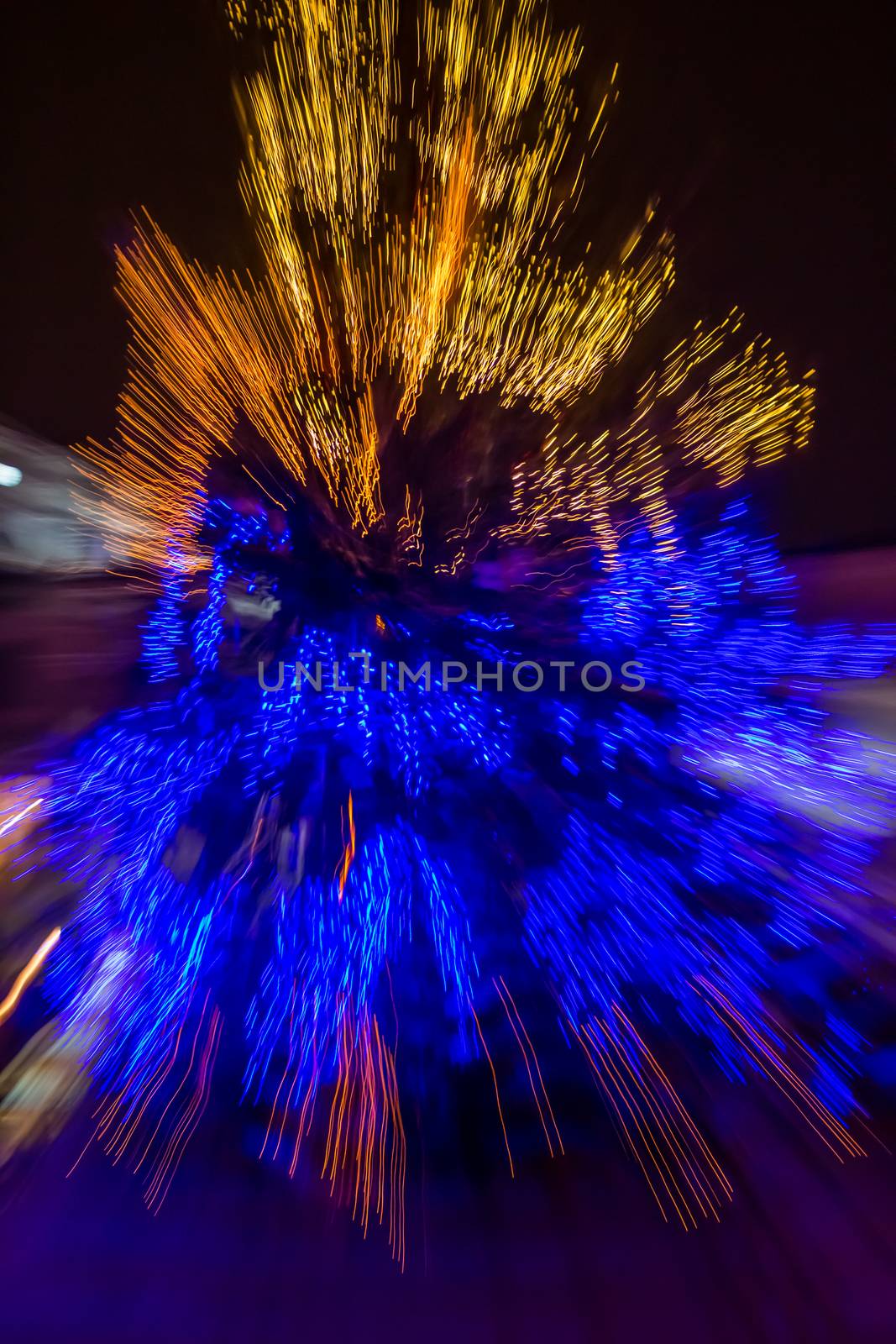 abstract blur of christmas tree on old european city street at night