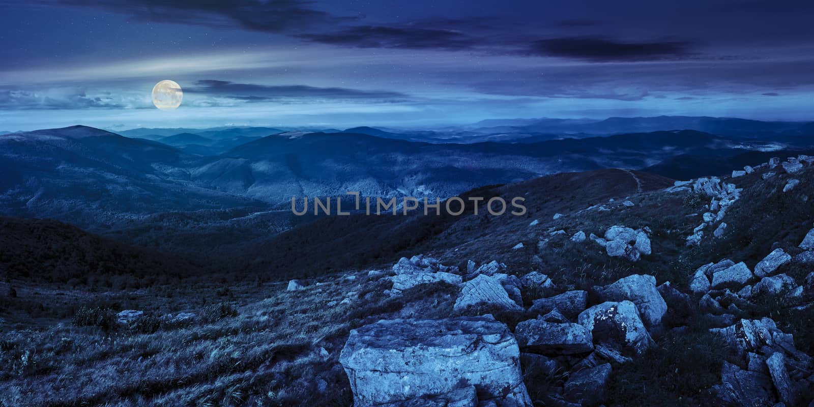 stones in valley on top of mountain range at night by Pellinni