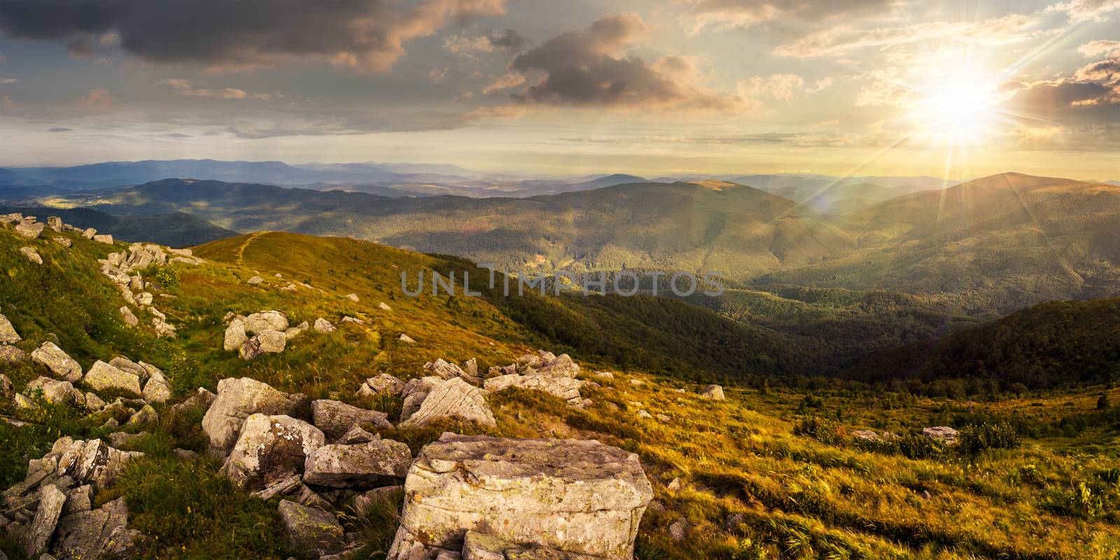 stones in valley on top of mountain range at sunset by Pellinni