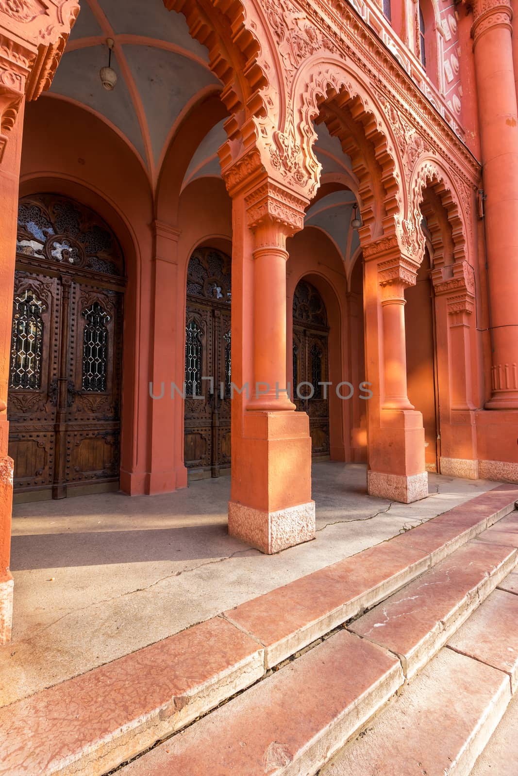 arch enter to old red synagogue with wooden doors