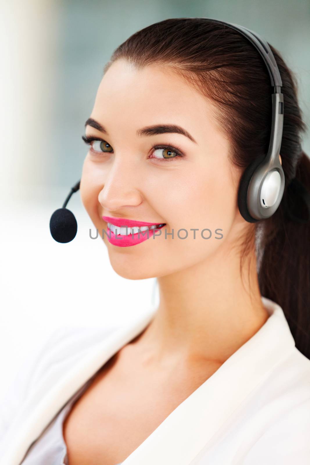 Closeup portrait of support phone operator in headset at workplace