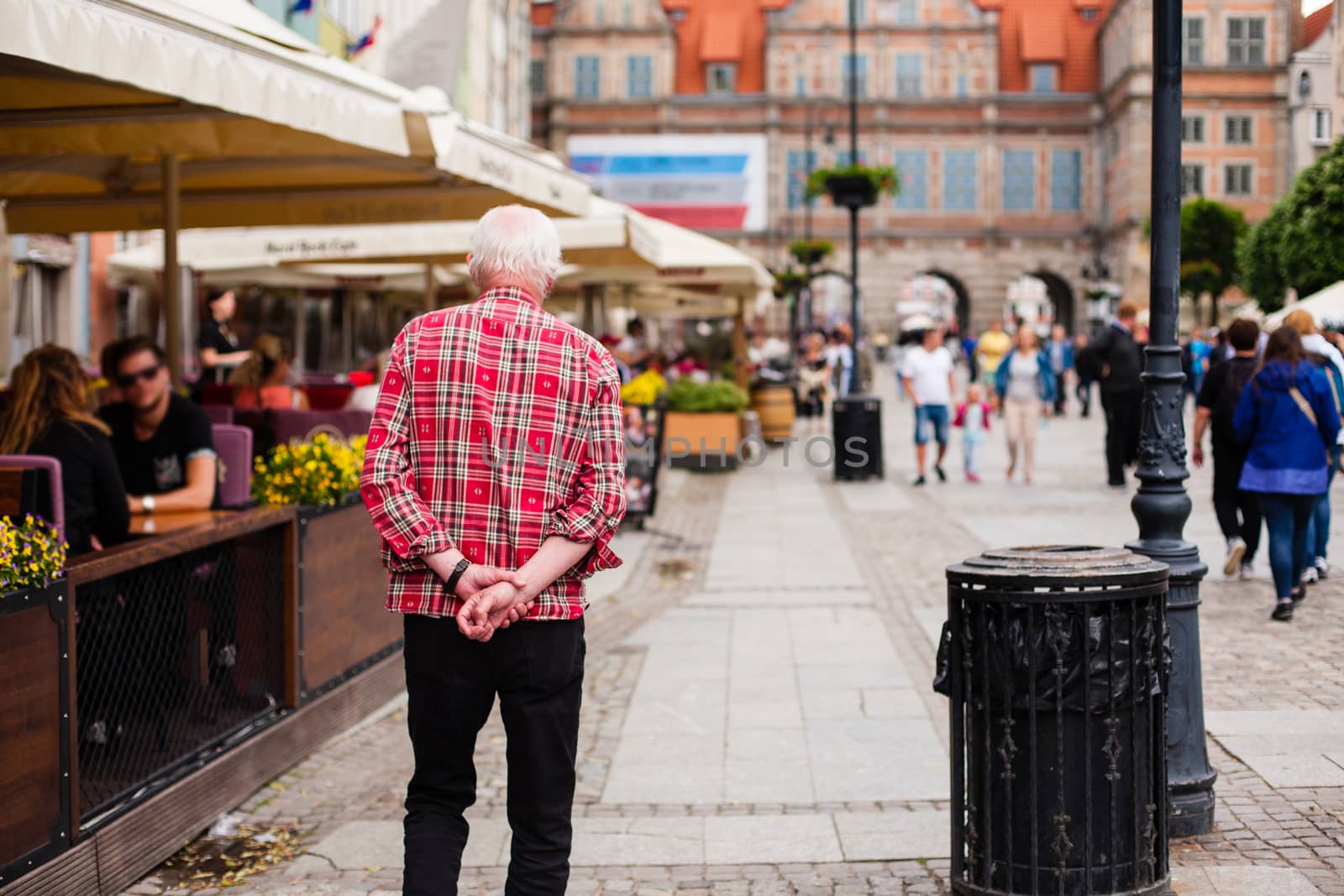 Poland, Gdansk - June 12, 2017 : Urban life. Old lonely man goes in A Big City Street